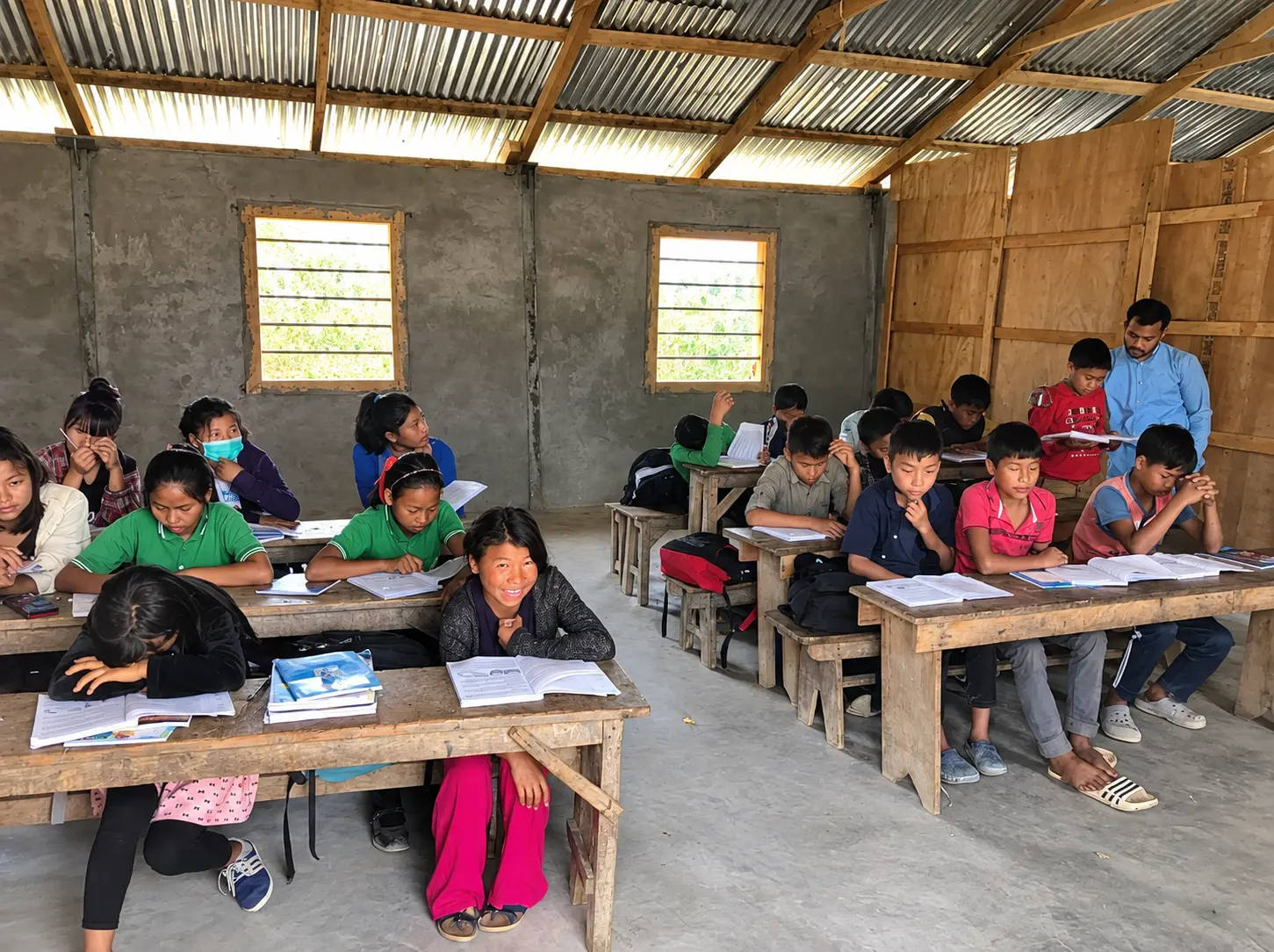 Children learning in a simple classroom