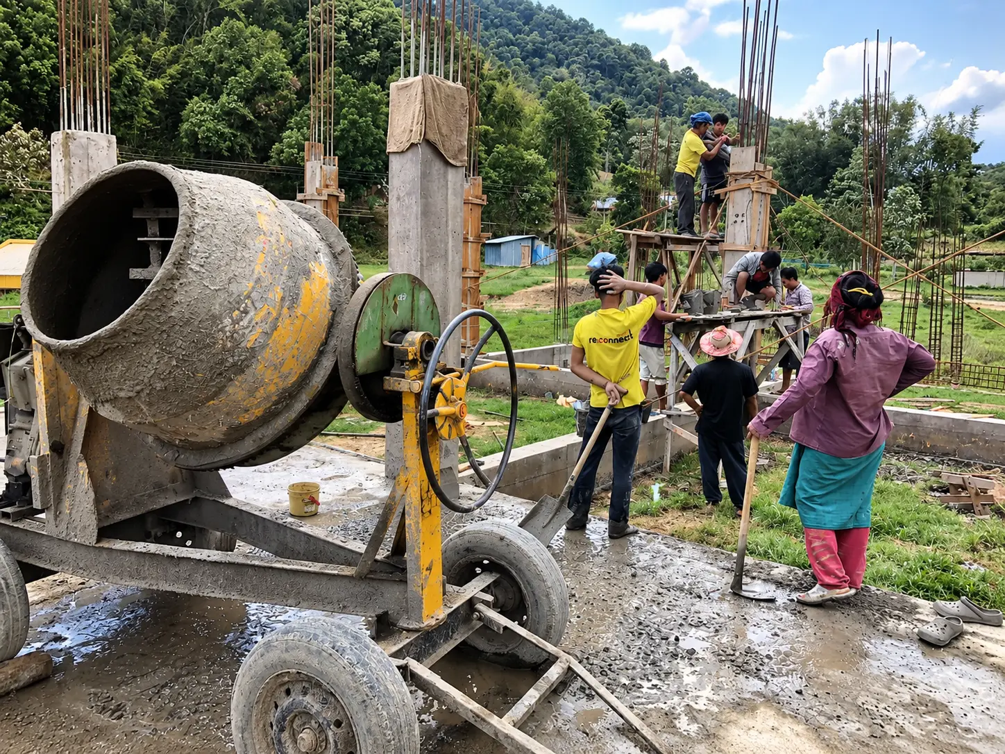 Workers mixing concrete at a school construction site