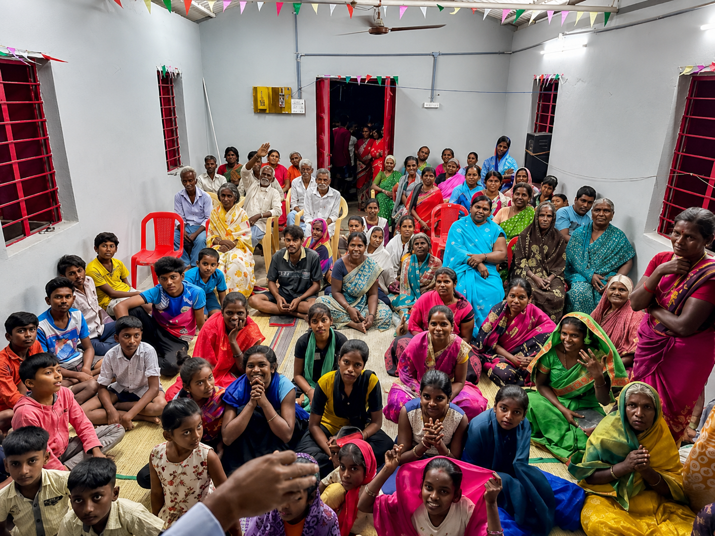 A packed village congregation of families seated inside a newly restored church