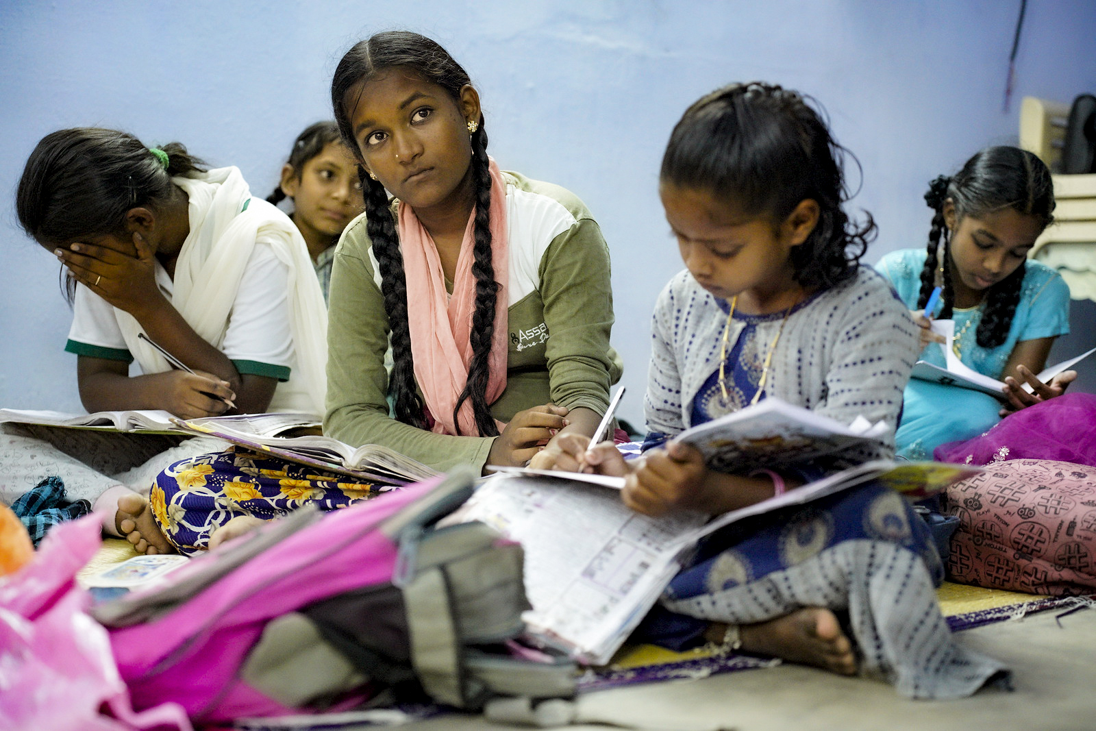 Girls studying together in an evening school in Asia